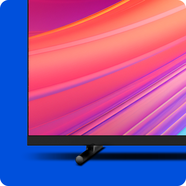 Uma TV com cores puxadas para o rosa e vermelho e um plano de fundo azul.