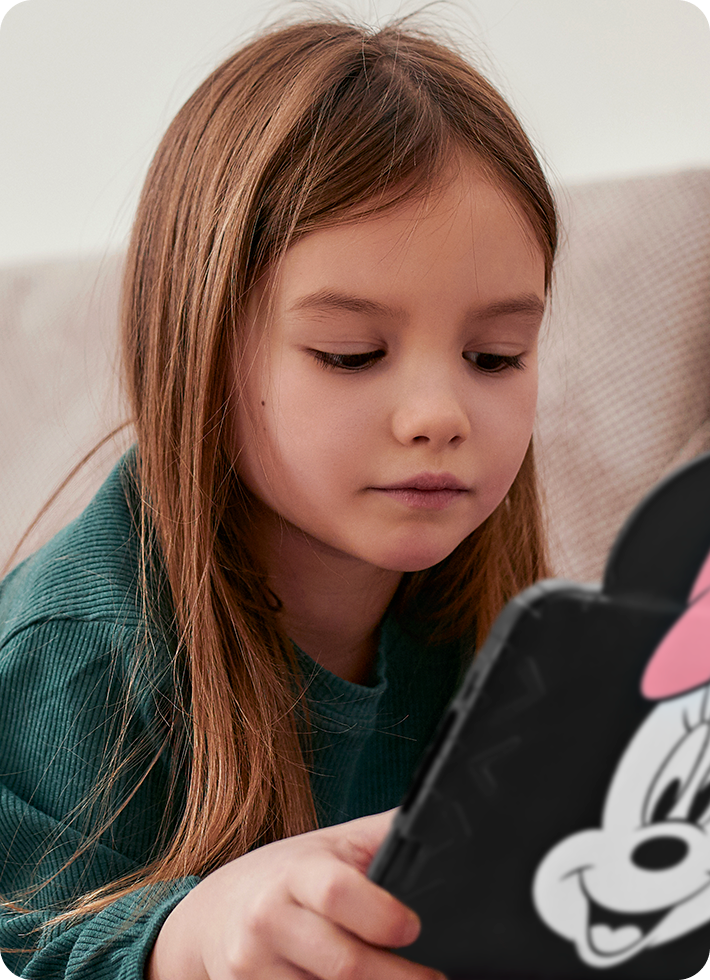 Foto de uma criança mexendo no Tablet Minnie.